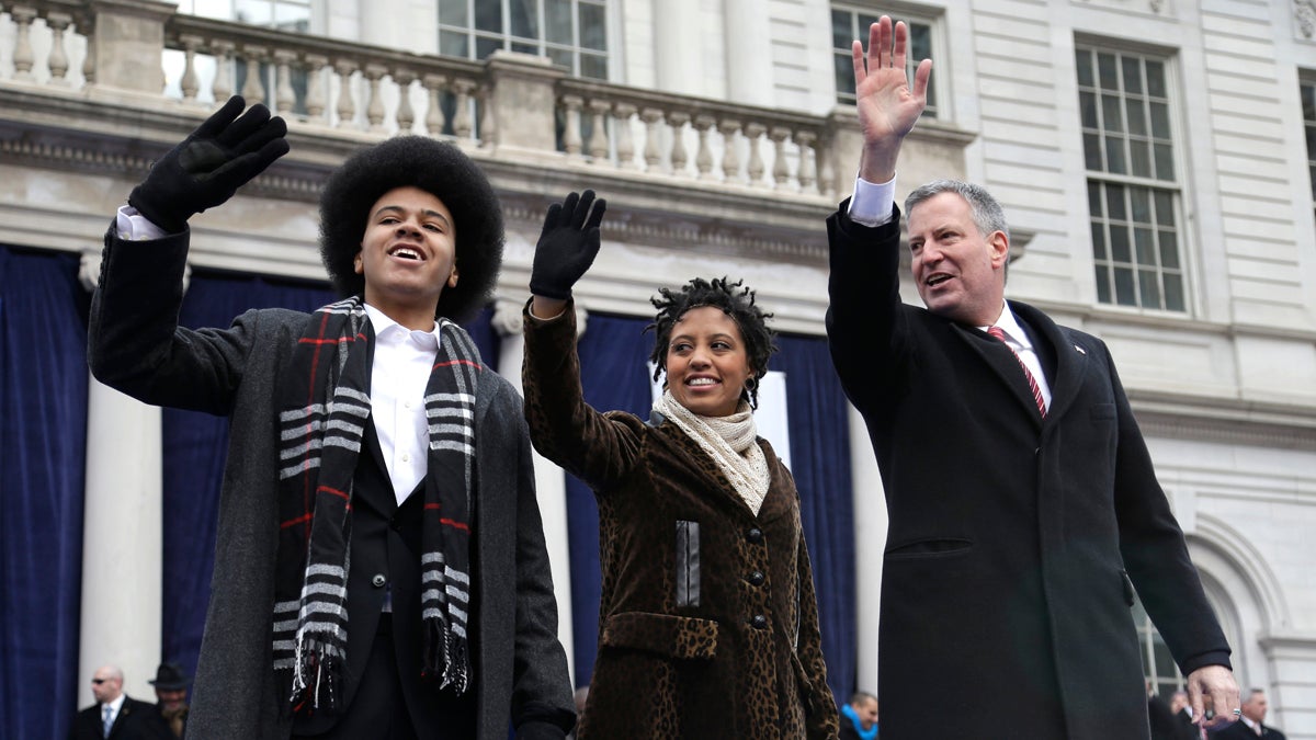  New York City Mayor Bill de Blasio, right, is shown with his children, Dante, left, and Chiara de Blasio on Jan. 1, 2014, waving to the crowd after the mayor took the oath of office during the public inauguration ceremony. (AP Photo/Seth Wenig) 
