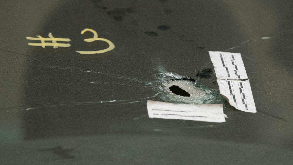  Shown is a bullet hole in Philippe Holland's windshield in Philadelphia Jan. 6. Holland, a pizza deliveryman,  shot and injured when plainclothes police fired 14 times at his car has negotiated a $4.4 million settlement with the city of Philadelphia. (AP Photo/Matt Rourke) 