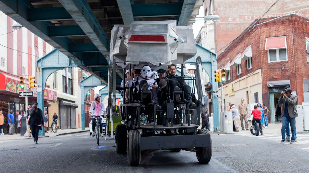 A Star Wars-themed vehicle makes its way down Front Street.