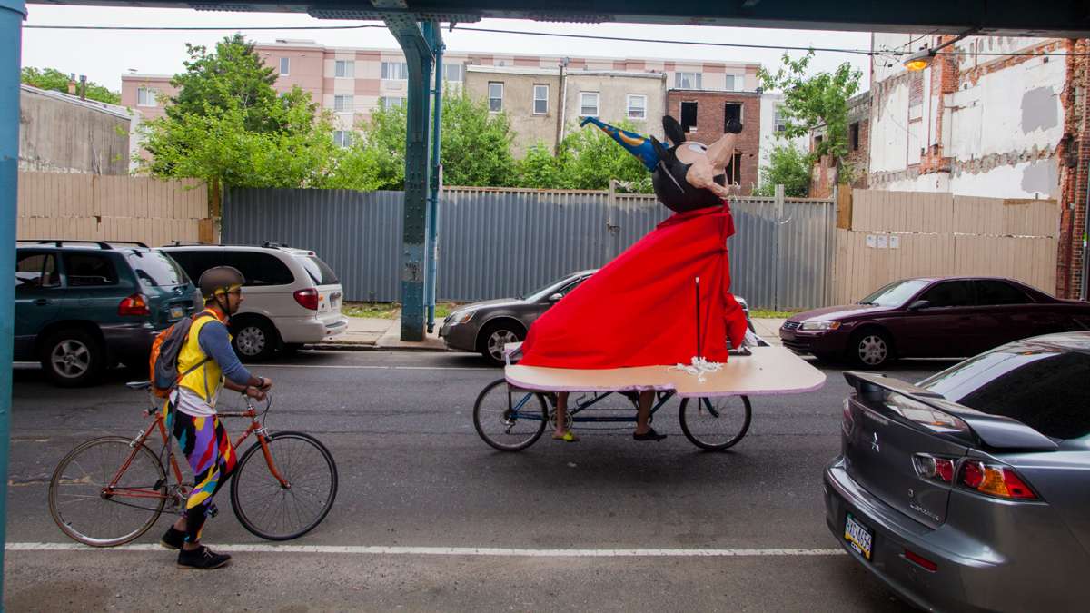 A kinetic sculpture in the form of Mickey Mouse as the Sorcerer's Apprentice wheels down Front Street