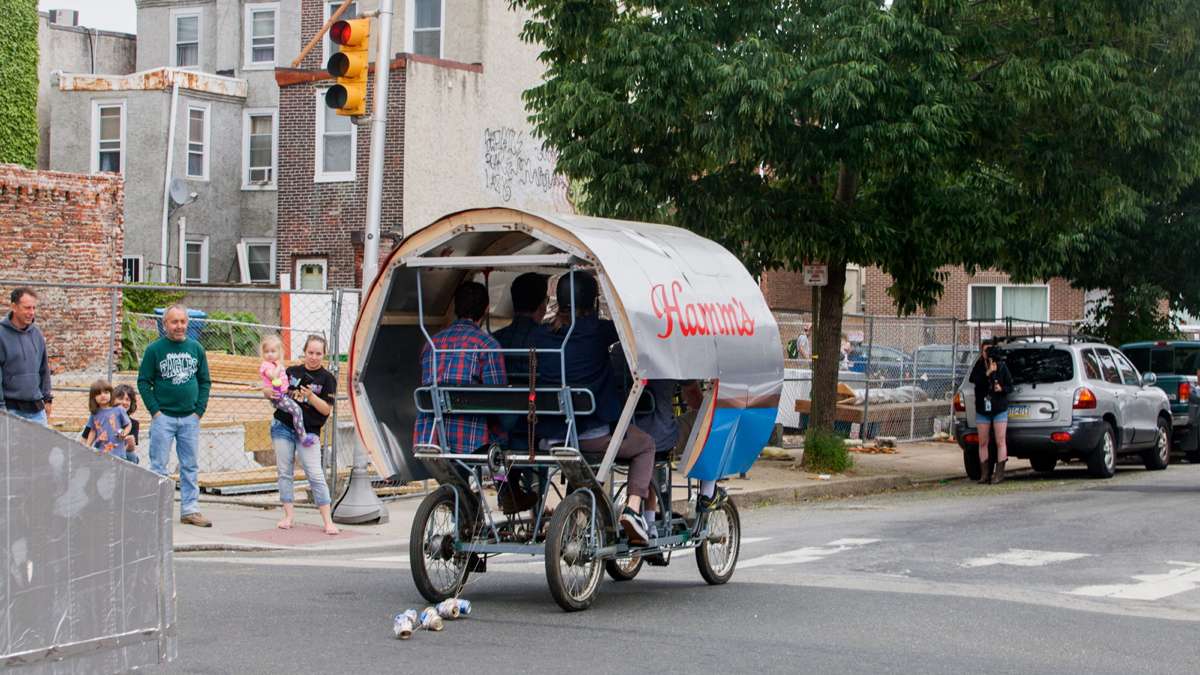 The Hamm's-Sters team pedal their oversize Hamm's beer can through Fishtown