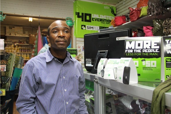 <p>Bakayoko Ben Hassan sells mobile internet devices at his shop on Woodland Avenue. (Emma Lee/for NewsWorks)</p>
