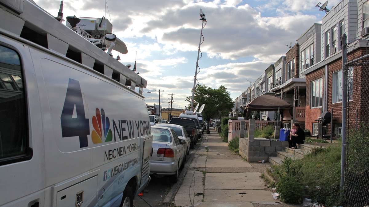 Media vans fill East Pike Street leading to the accident scene.