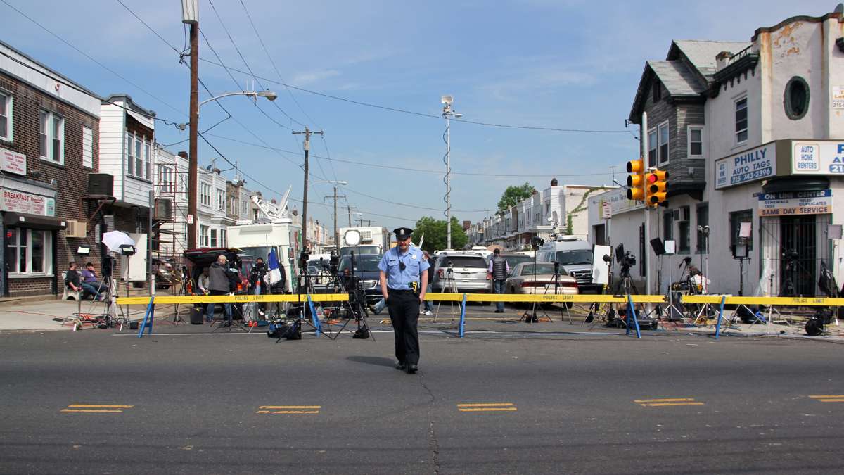 Police keep Frankford Avenue open by restraining media behind barricades on East Pike Street.
