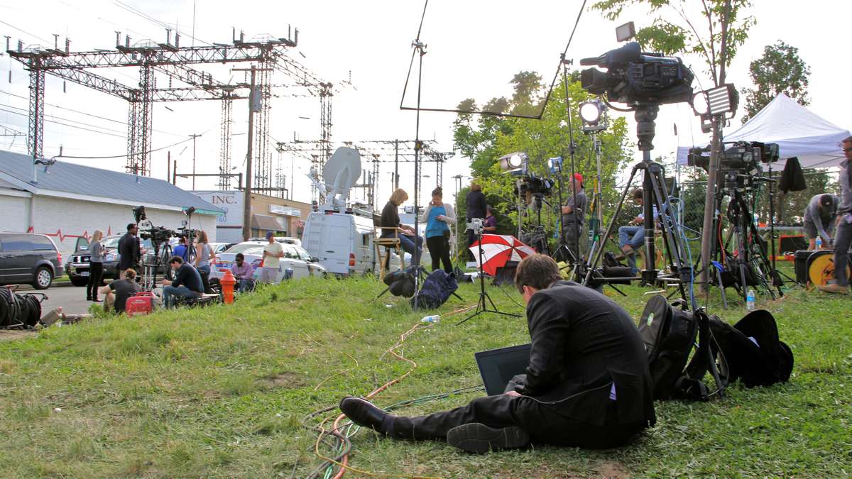 Journalists and camera crews set up camp on a vacant lot near the crash scene. (