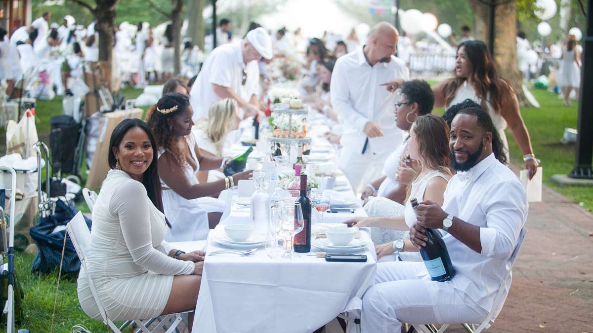 Participants in Dîner en Blanc bring their own tables, chairs, food, wine and tableware. (Brad Larrison for NewsWorks)