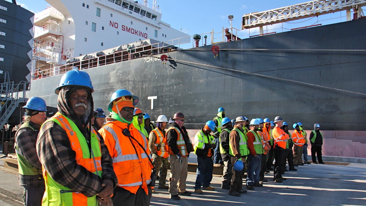  Dockworkers stand beside the massive ship Doric Warrior, ready to unload its cargo of steel at the newly opened Paulsboro Marine Terminal. (Emma Lee/WHYY) 