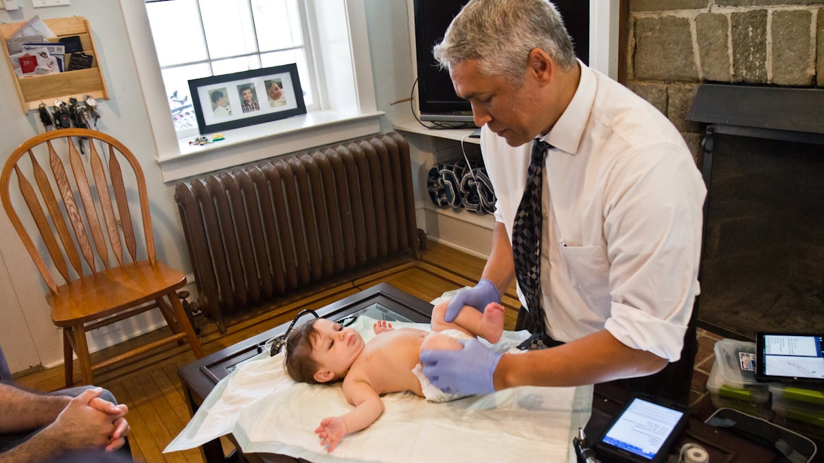  Pediatrician Andrew Wood vaccinates 6-month-old Maysa Abboud at a recent home visit. (Kimberly Paynter/WHYY) 