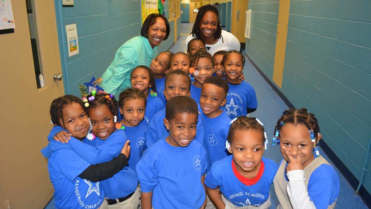  Danielle Scruse (top, left) poses with her kindergarten class in the freshly painted halls of Young Scholars Kenderton. (Kevin McCorry/ 