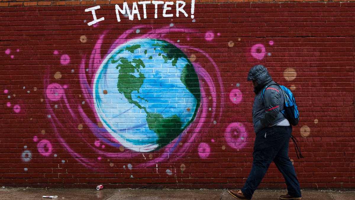  A man walks past a mural the day before Earth Day, in Philadelphia, Friday, April 21, 2017. (AP Photo/Matt Rourke) 