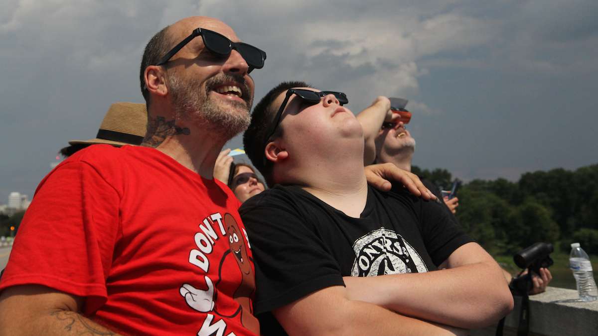 Louis and Parker Reed view the 2017 solar eclipse in Columbia, South Carolina. (Kimberly Paynter/WHYY)