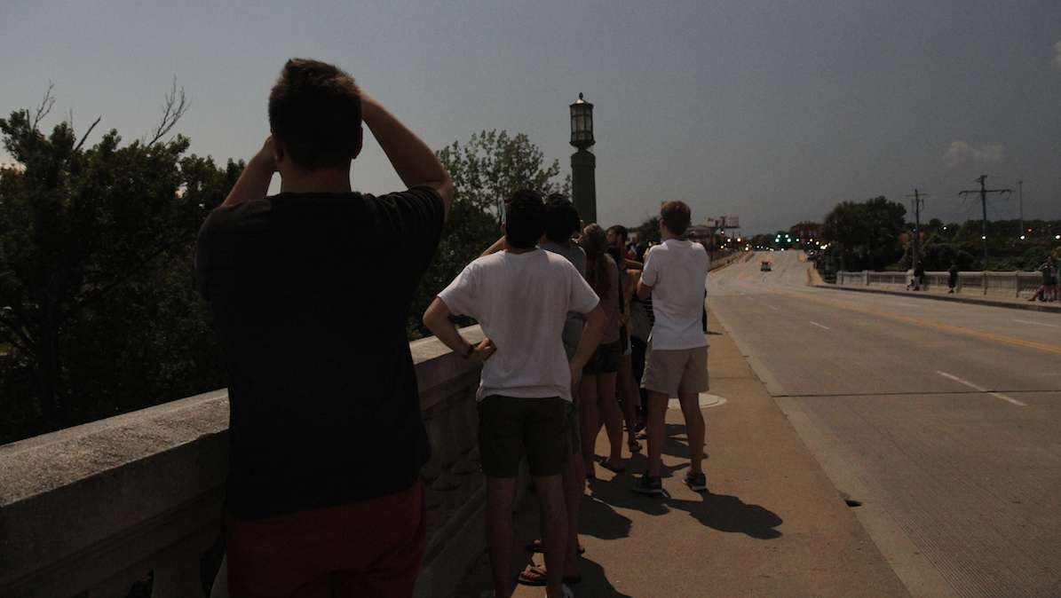 People gather on the Gervais Bridge in Columbia, South Carolina, during the 2017 total solar eclipse. (Kimberly Paynter/WHYY)