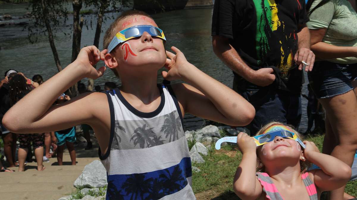 Logan and Chelsea Mills view the total solar eclipse in Columbia, South Carolina. (Kimberly Paynter/WHYY)
