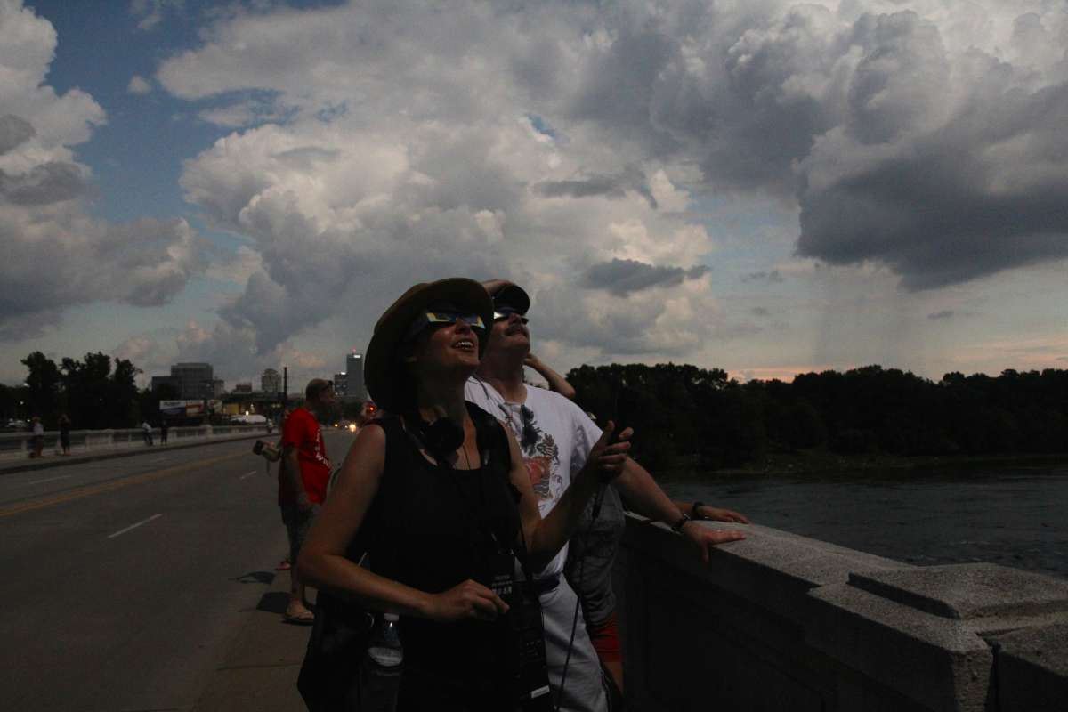 People gather on the Gervais Bridge in Columbia, South Carolina, during the 2017 total solar eclipse. (Kimberly Paynter/WHYY)