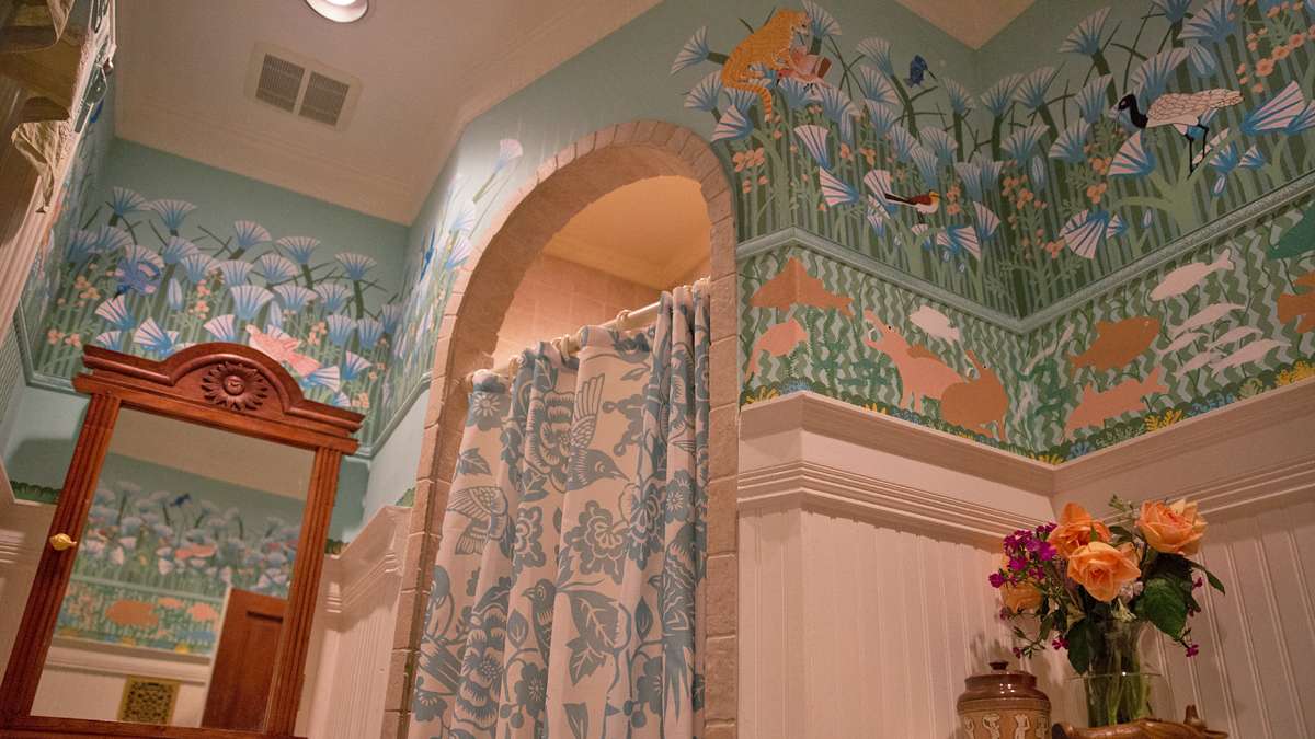Josef hand-painted a mural of the banks of the Nile with birds and lotus flowers on the bathroom wall.  (Lindsay Lazarski/WHYY)