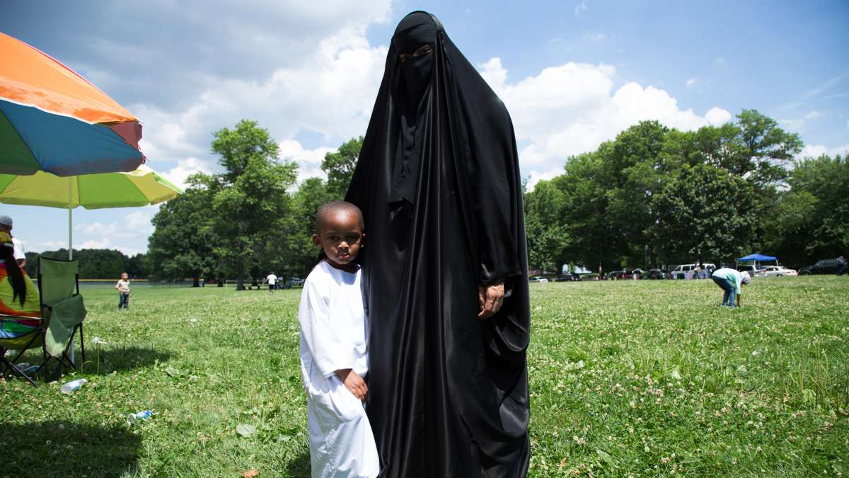 A woman and her son pose for a portrait