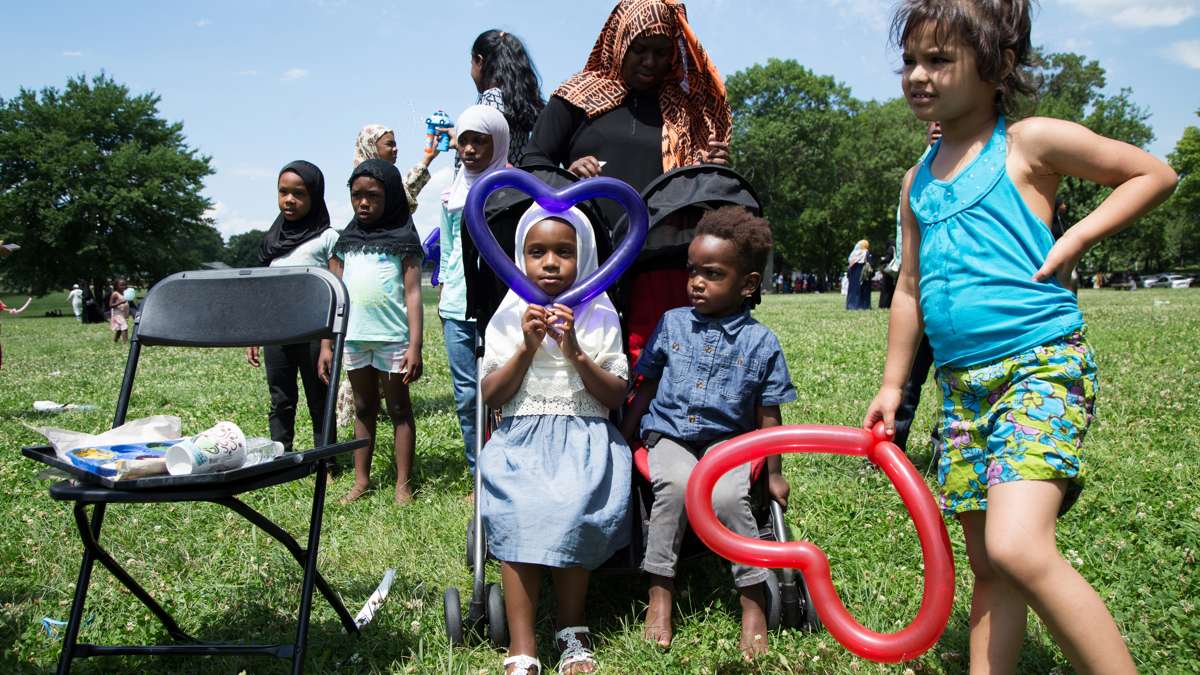 Children wait for balloon animals at Eid al-Fitr festivities in FDR Park