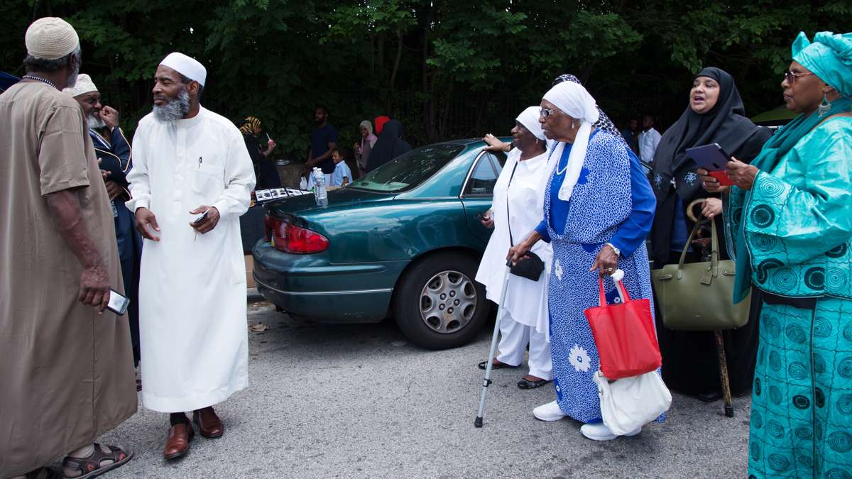 Fatimah (right, in blue), who converted to Islam before the large waves of conversions in the 60s and 70s, walks towards Clara Muhammad Square