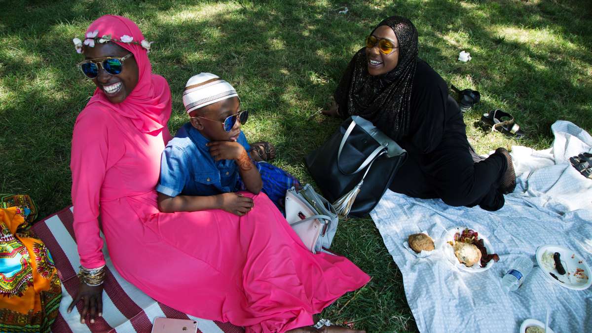 Friends relax in Clara Muhammad Square after Eid prayers