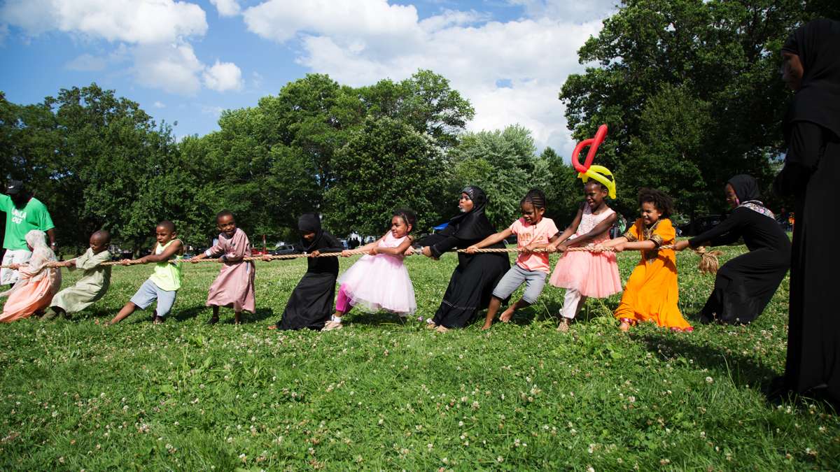 Children play a game of tug of war at Eid al-Fitr festivities in FDR Park