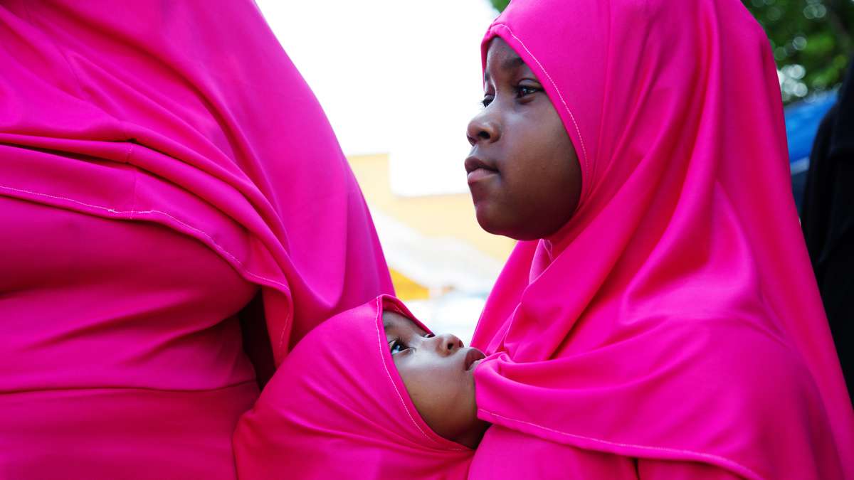 Two sisters watch Eid al-Fitr festivities at Clara Muhammad Square