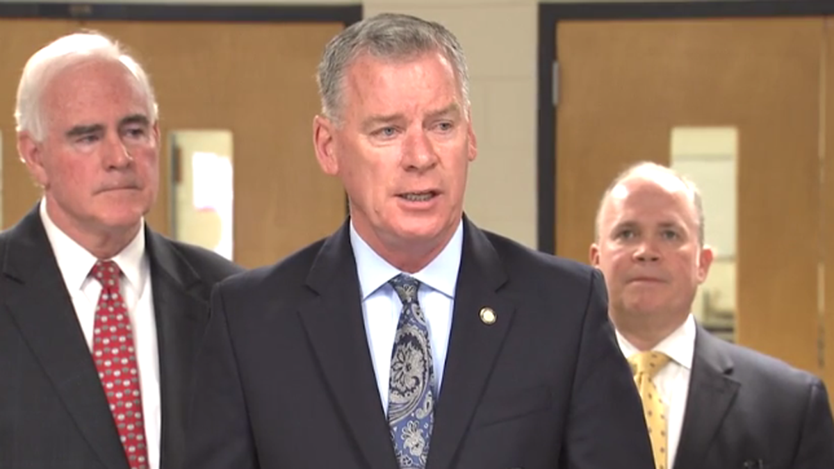 State Senator Tom McGarrigle speaks about his plans to introduce a bill diverting federal housing subsidies from tax delinquent landlords at a news conference in the William Penn School District. (Laura Benshoff/WHYY) 