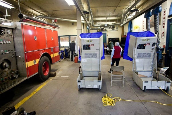 <p><p><span style="font-size: 12pt; line-height: 115%; font-family: 'Helvetica','sans-serif';">Voters and poll workers at Fire Engine #37 in Chestnut Hill Tuesday. (Brad Larrison/ for NewsWorks)</span></p></p>
