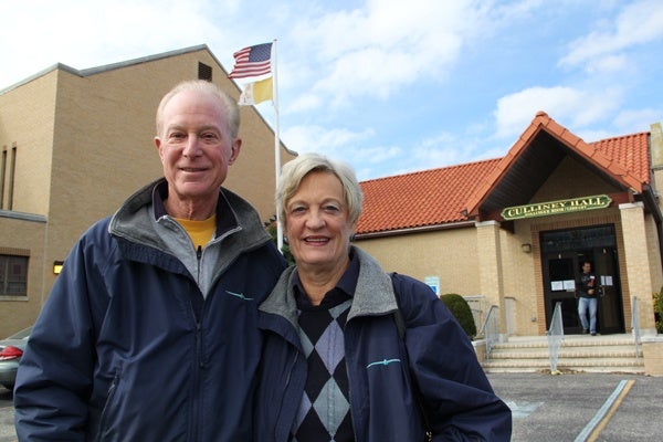 <p>Ocean City residents Peter and Debbie Beck leave St. Francis Cabrini Church after voting. They said the President's handling of the storm didn't affect the way they voted. (Emma Lee/for NewsWorks)</p>
