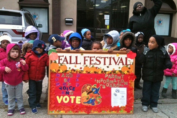 <p>Children from?Arising Futures Child Care and Development Center urge passers by to vote at Green and Rittenhouse Streets in Germantown.  (Shai Ben-Yaacov/WHYY)</p>
