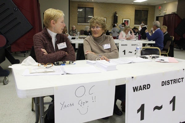 <p>Susan Gailey and Joyce Bakley-Trofa tend the table for voters who usually vote at the Ocean City Yacht Club. The polling place was relocated to St. Francis Cabrini Church, where three other districts vote. (Emma Lee/for NewsWorks)</p>
