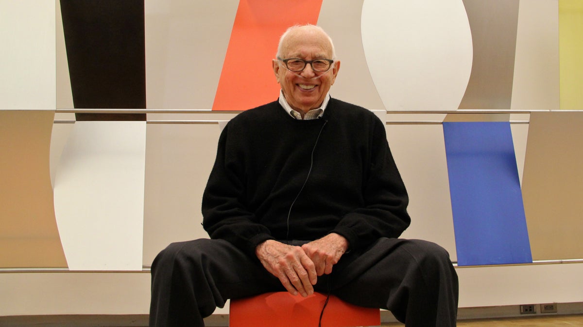 Ellsworth Kelly, who died Sunday at the age of 92, is shown sitting in front of his first monumental wall sculpture, 12 feet high and 67 feet wide. The work was exhibited at the Barnes in Philadelphia in 2013 for a celebration of the artist's 90th birthday.  (Emma Lee/for NewsWorks) 