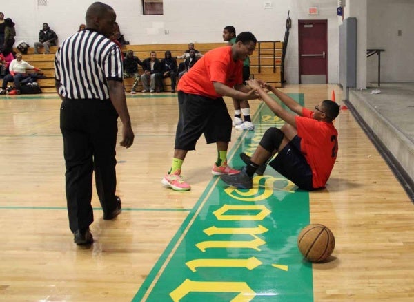 <p><p>Dayton Melton of the Brickyard neighborhood helps a teammate to his feet after a hard foul at Simons Recreation Center.  (Emma Lee/ For NewsWorks)</p></p>
