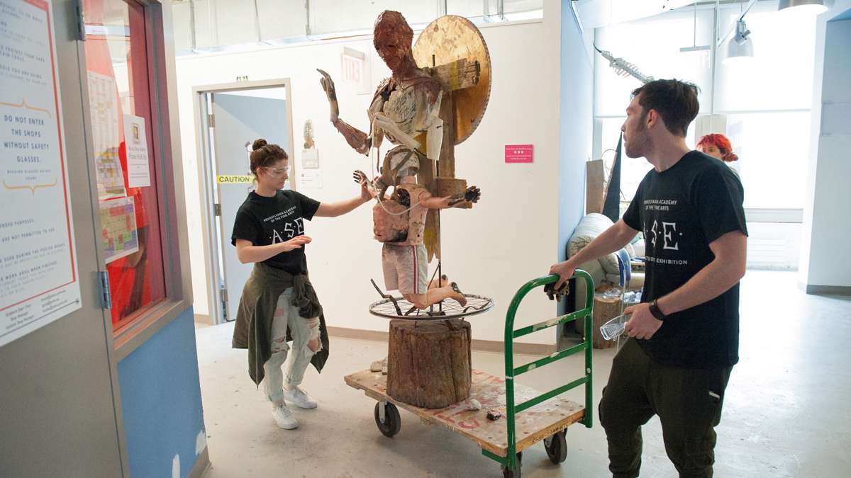 Michel Amabile, right, and Julia McGehean move one of Amabile's sculptures from his studio to the gallery.