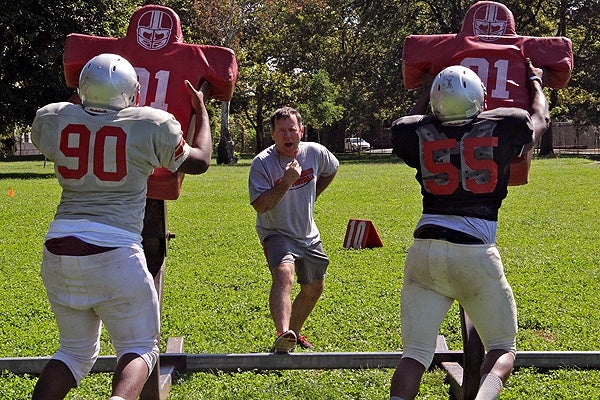 Mustangs coach John Sullivan runs a summer practice at Dobbins-Randolph Vo-Tech High School.