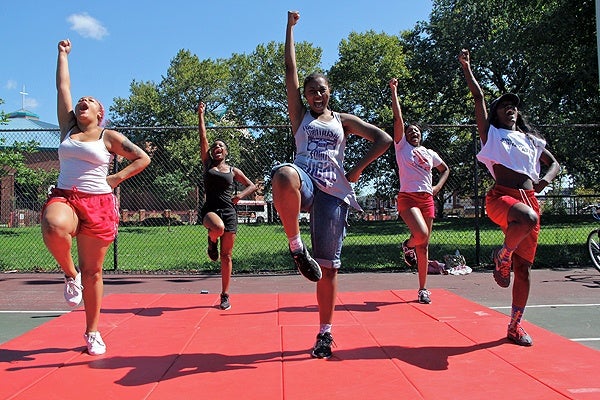 Shatoni Caldwell leads the Dobbins-Randolph Vo-Tech High School competitive spirit cheer team during a summer practice on the tennis courts at Reyburn Park.