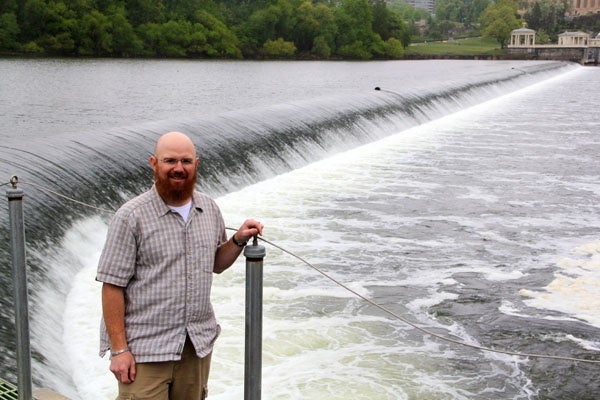 Fisheries biologist Joe Perillo stands above the Fairmount Dam. A nearby fish ladder helps fish such as the American shad reach their spawning grounds upriver. (Emma Lee/for NewsWorks)