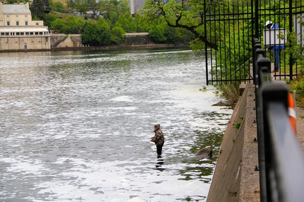 Fishermen try their luck in the Schuylkill near the Fairmount Dam. Fishing is prohibited within 100 feet of the fish ladder. (Emma Lee/for NewsWorks)
