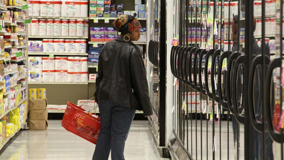A customer browses the refrigerated cases at Fare and Square. (Emma Lee/WHYY)