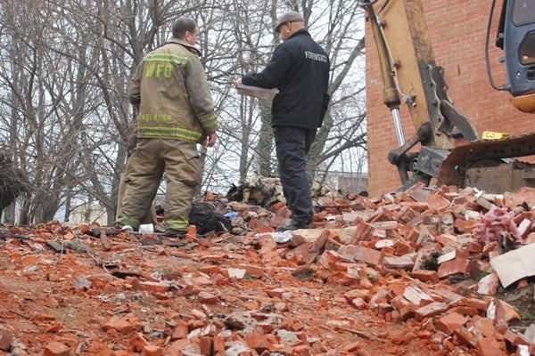 <p><p>Investigators stand among the rubble of the the W. 5th Street house that partially-collapsed during a fire on December 13. (John Jankowski/for NewsWorks)</p></p>
