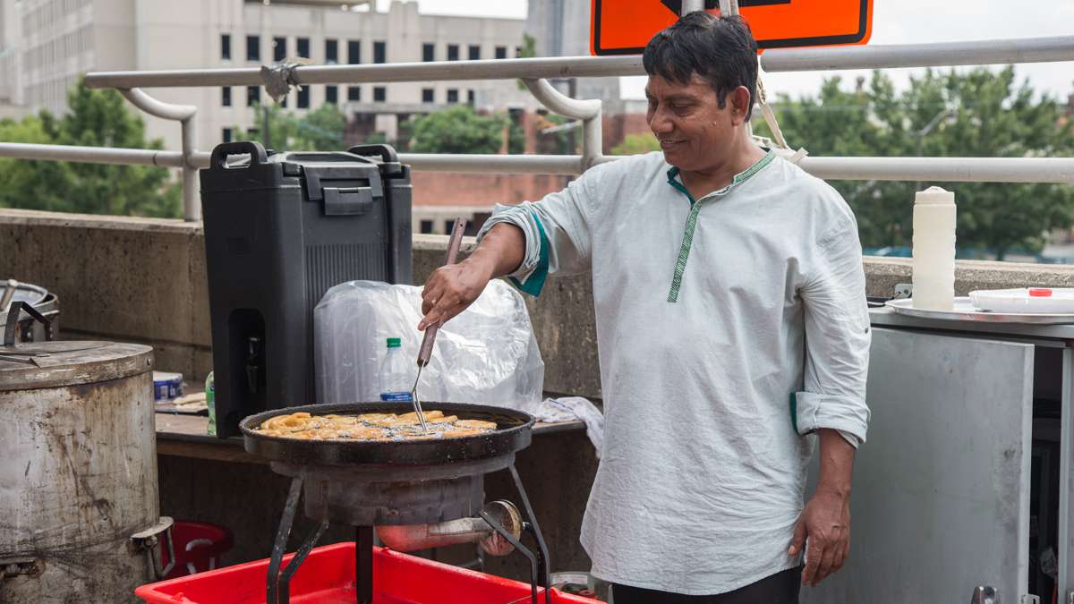 A man makes Jalebi, an Indian version of funnel cake, at the Festival of India at Penn's Landing. (Emily Cohen for NewsWorks)