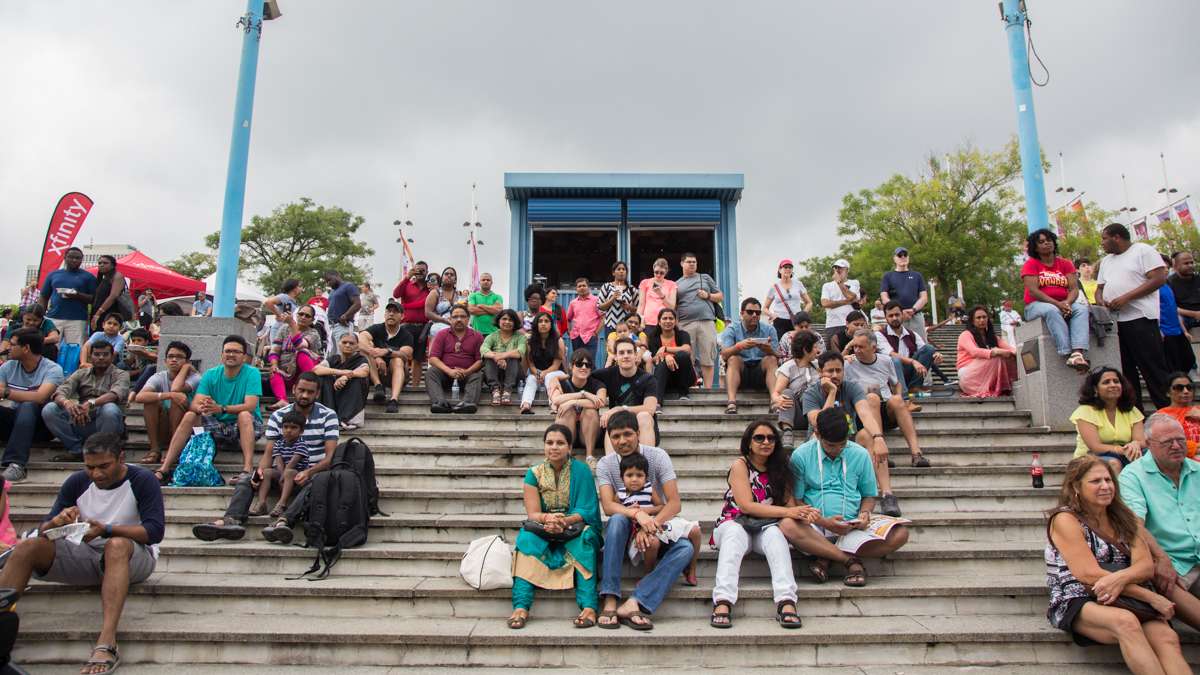 A crowd gathers on the steps to watch the dancers at the Festival of India at Penn's Landing. (Emily Cohen for NewsWorks)