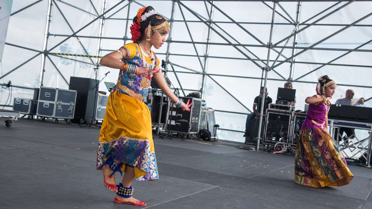 Dancers perform with their bare feet painted to resemble red shoes during the Festival of India at Penn's Landing Saturday, Aug. 12, 2017. (Emily Cohen for NewsWorks)