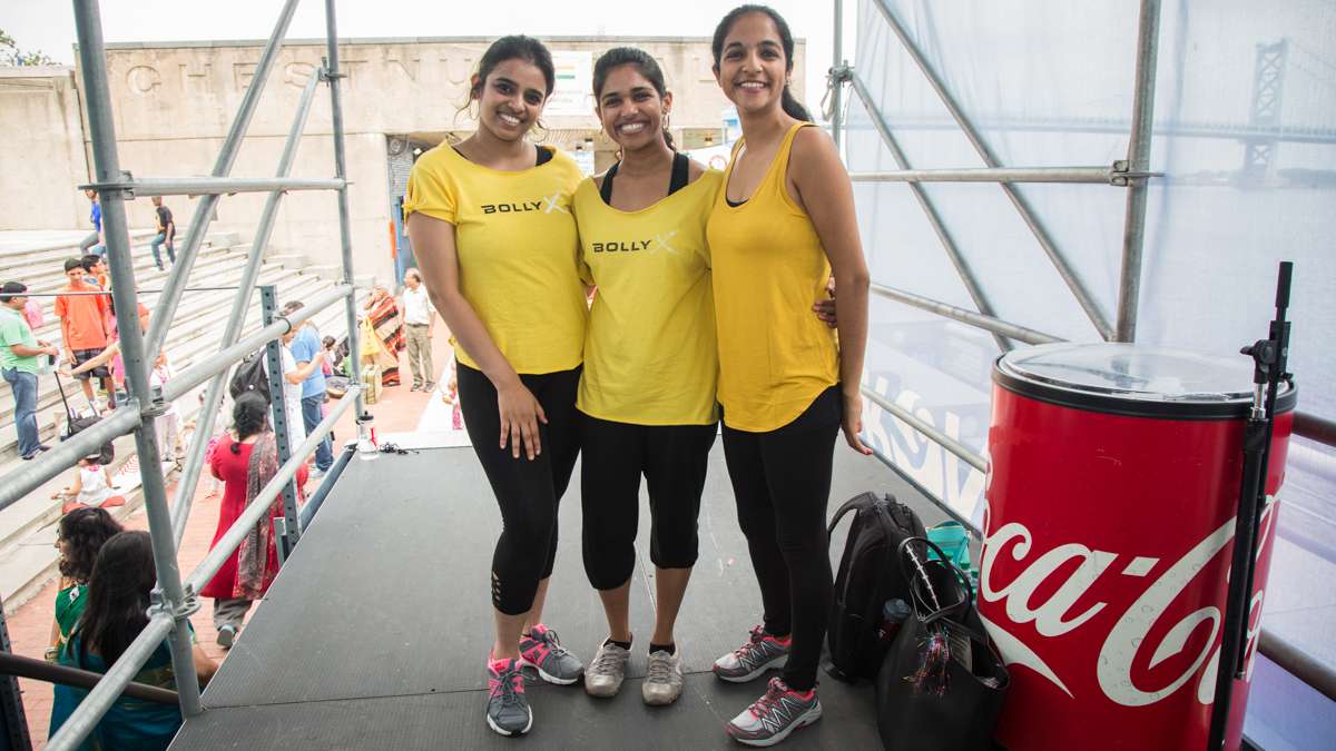 Performers (from left) Varsha Balu, 30, Teens Varghese, 26, and Ithi Joshi, 26, pose before showing off their BollyX excercise routine which they describe as Zumba meets Bollywood. They teach the class in Philadelphia and West Chester. (Emily Cohen for NewsWorks)