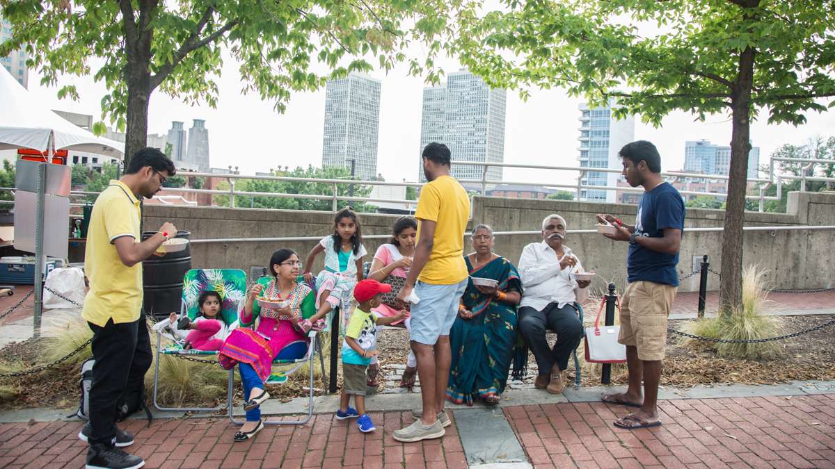 A family gathers at Penn's Landing for the Festival of India, a celebration 70th anniversary of India's independence from the British Empire. (Emily Cohen for NewsWorks)