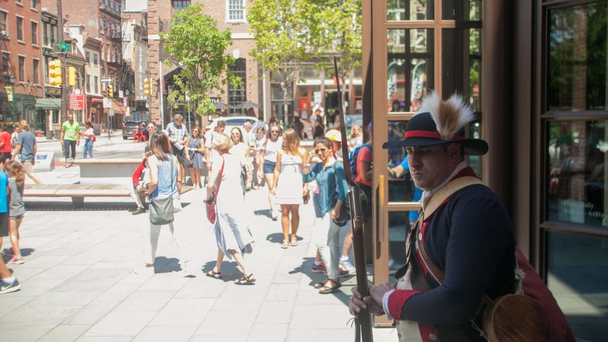 A Revolutionary War Renactor stands outside of the Museum of the American Revolution Saturday. (Brad Larrison for NewsWorks)