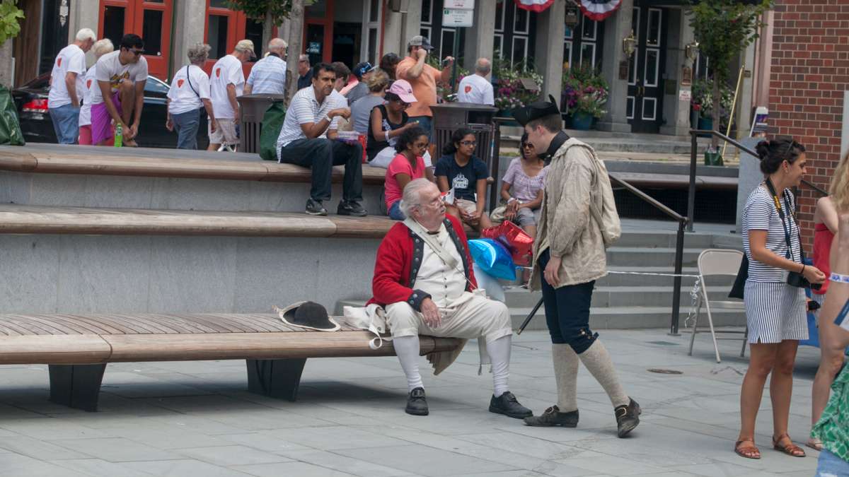 Performers at the Museum of the American Revolution talk before a fife and drum party to teach museum goers about the role music played in America's war for independence. (Brad Larrison for NewsWorks)