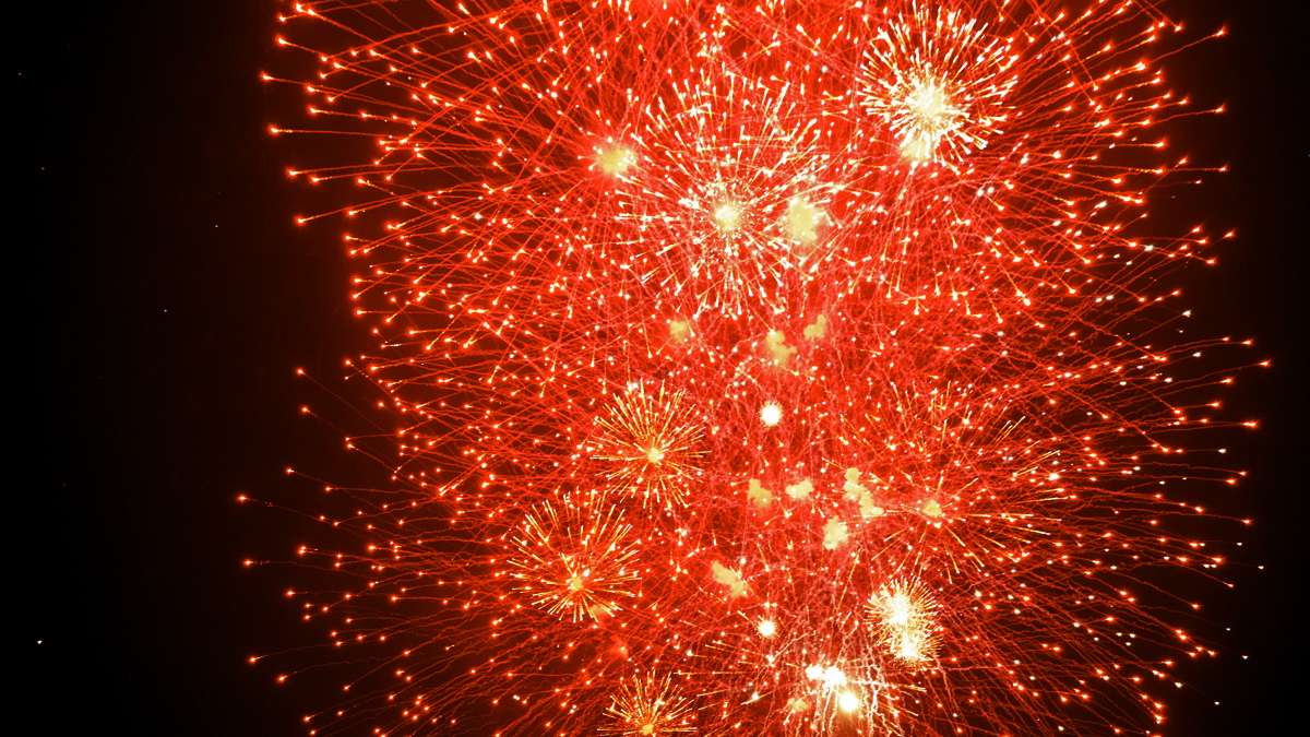 Fireworks explode over the Delaware River as seen from Penn's Landing.