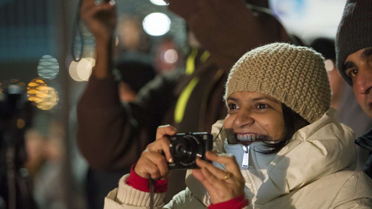Priti Navelcar photographs the finale of the midnight fireworks display from Penn's Landing.
