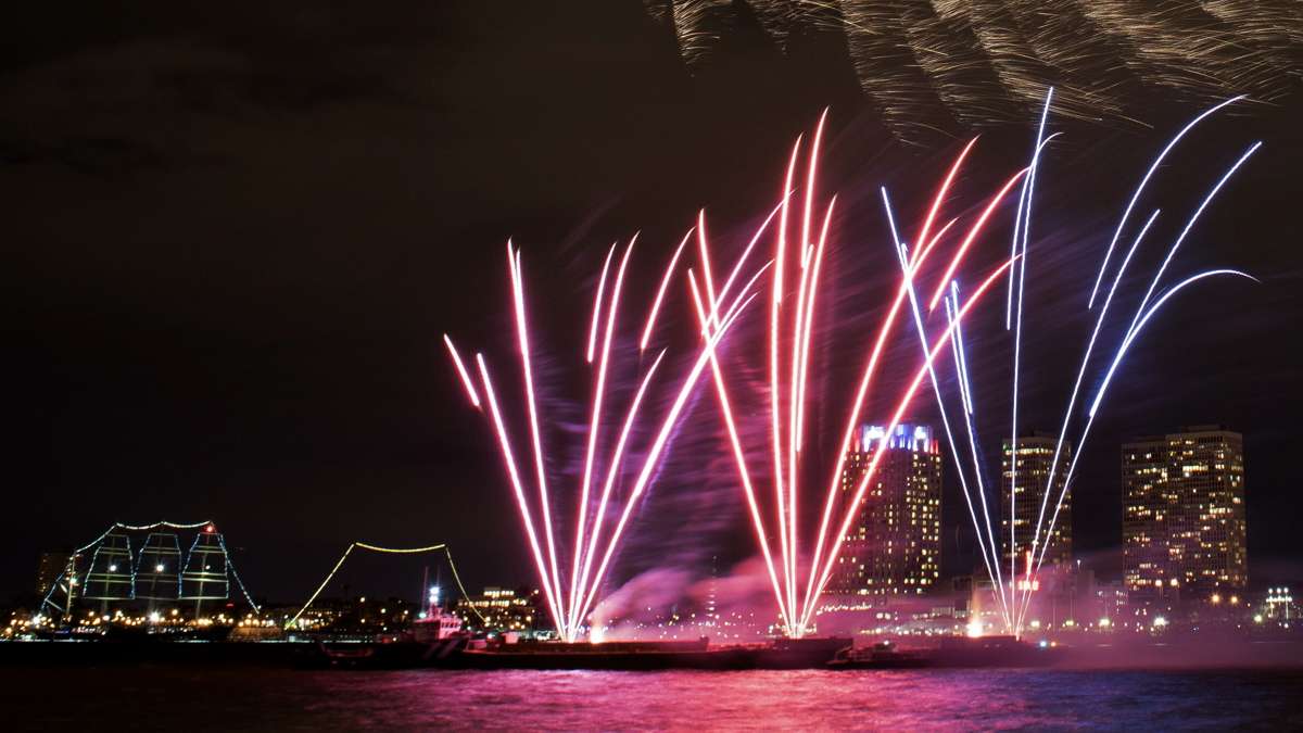 A view of the 6 p.m. display of the New Year's fireworks as seen from the Camden Waterfront with Penn's Landing and Society Hill in the background.
