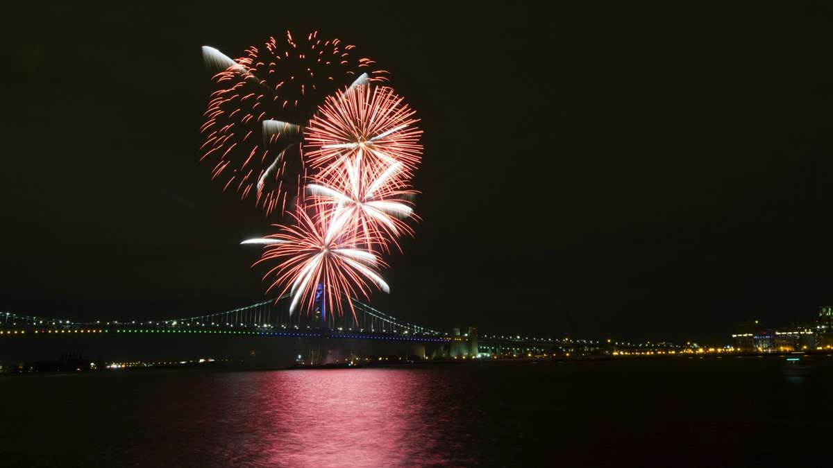 Fireworks are seen from Penn's Landing with the Benjamin Franklin Bridge in the background.